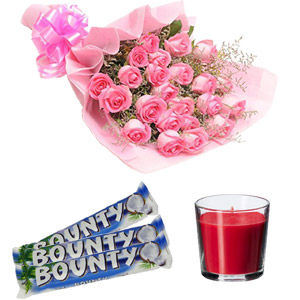 Pink roses with chocolate and candle